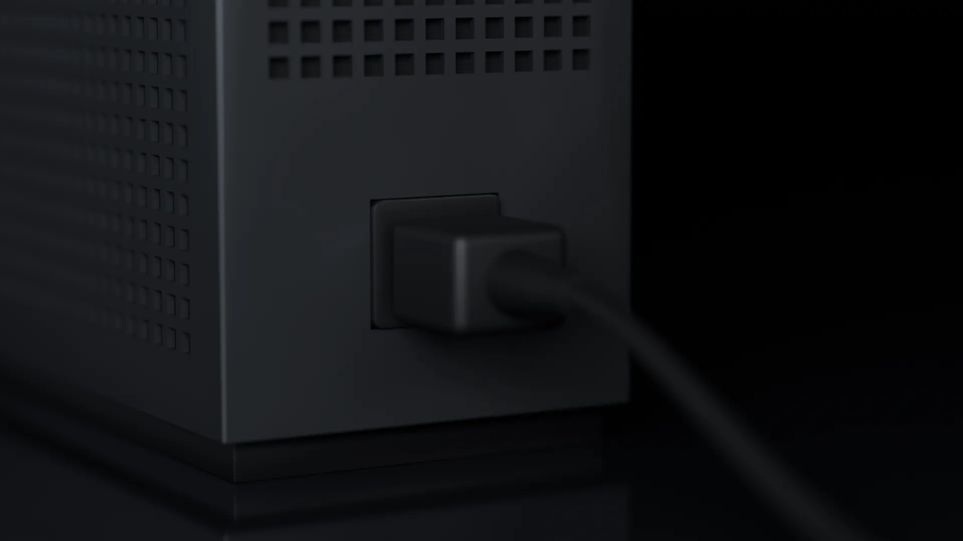 A power cable plugged into the single socket on the back of the box